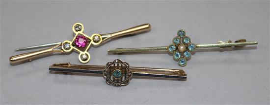 Three assorted early 20th century 15ct gold and gem set cluster bar brooches including aquamarine and diamond, largest 57mm.